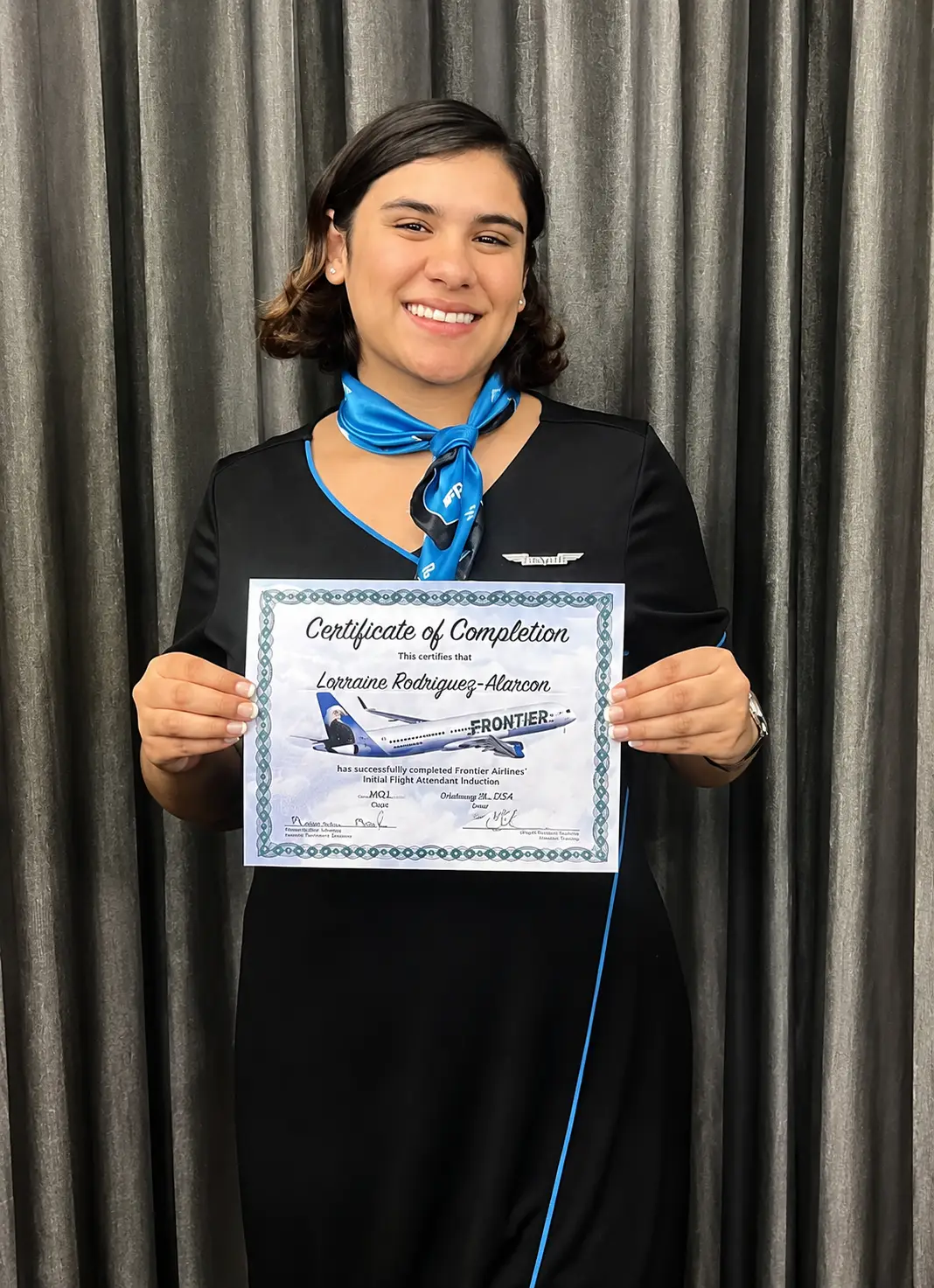Flight attendant graduate holding her certificate