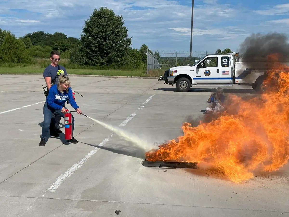 Flight attendant students during a live fire suppression training drill