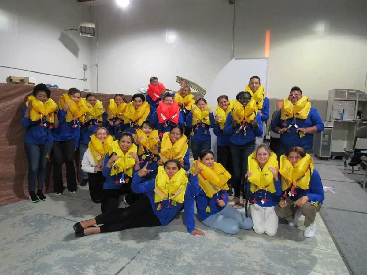 Flight attendant students training with flotation devices