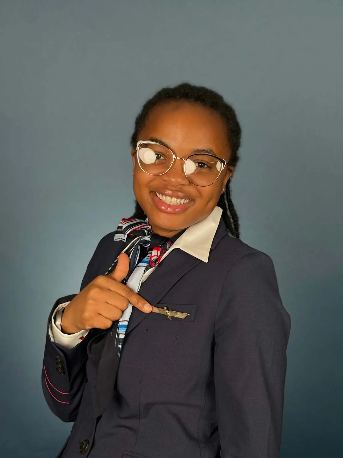 Flight attendant student pointing at her wings pin