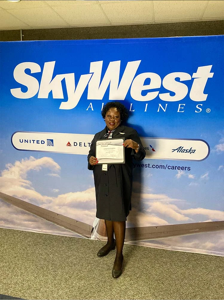 SkyWest flight attendant graduate holding her certificate