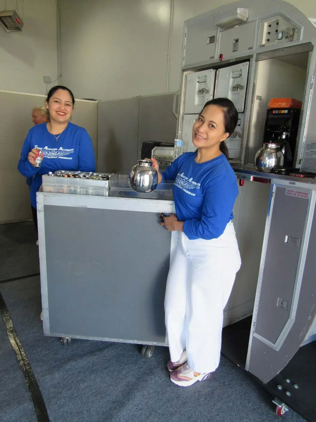 Flight attendant student with a coffee card at the hangar