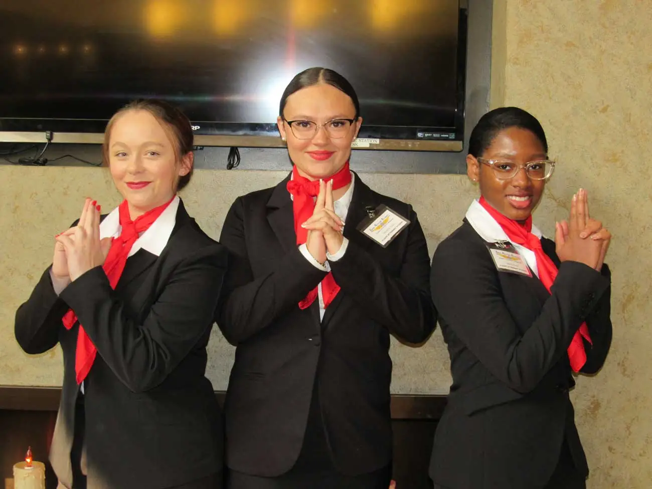 Flight attendant students posing playfully for a picture