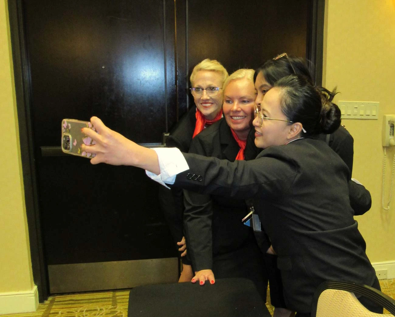 Flight attendant students taking a group selfie during training