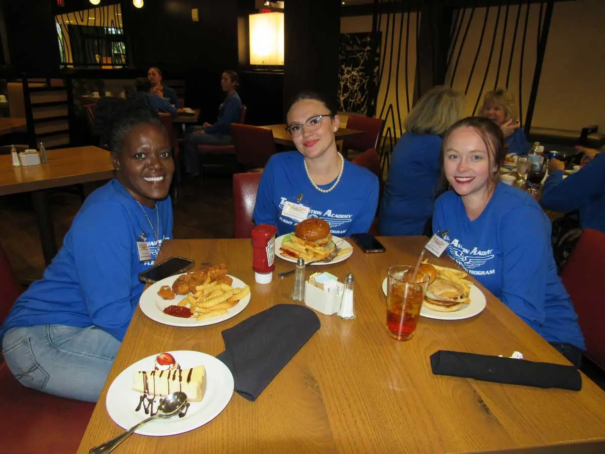 Flight attendant students in TAA hoodies eating at the campus cafe