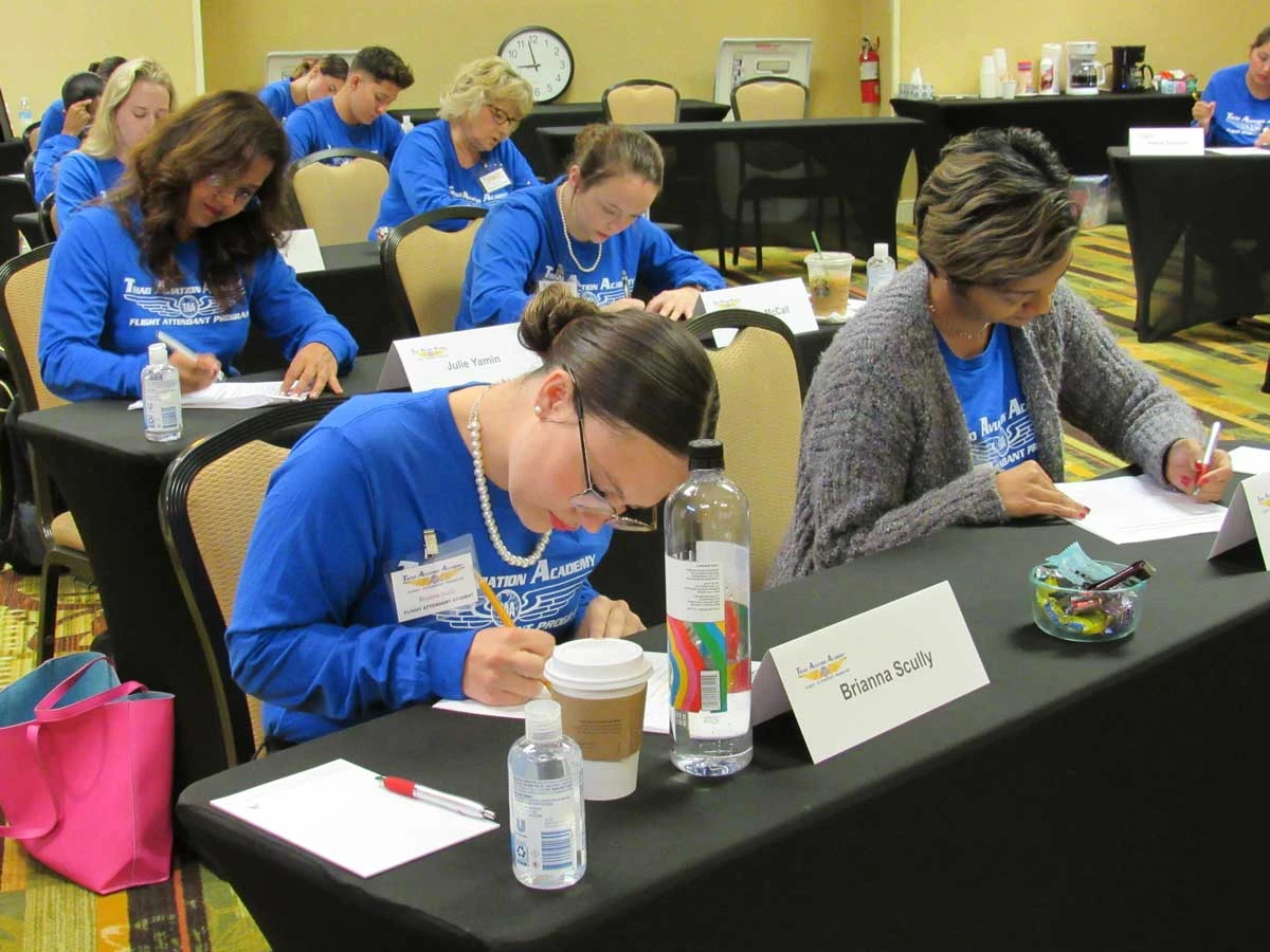 Flight attendant students studying together with laptops