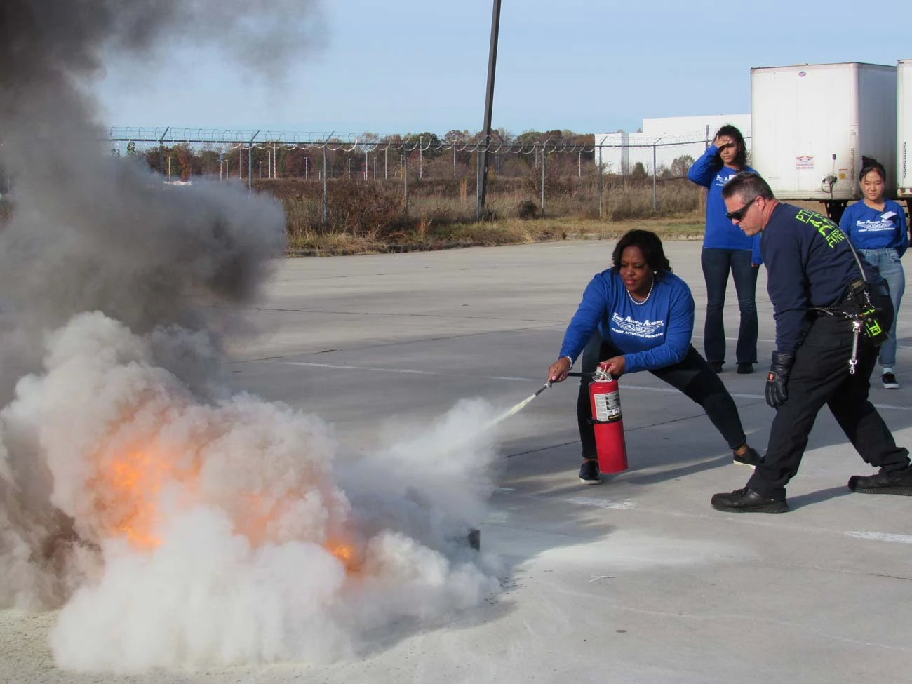 Flight attendant student practicing fire suppression training