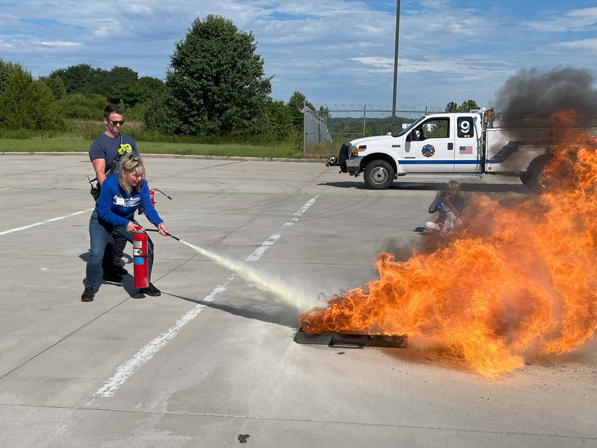 Flight attendant student participating in a live fire suppression drill