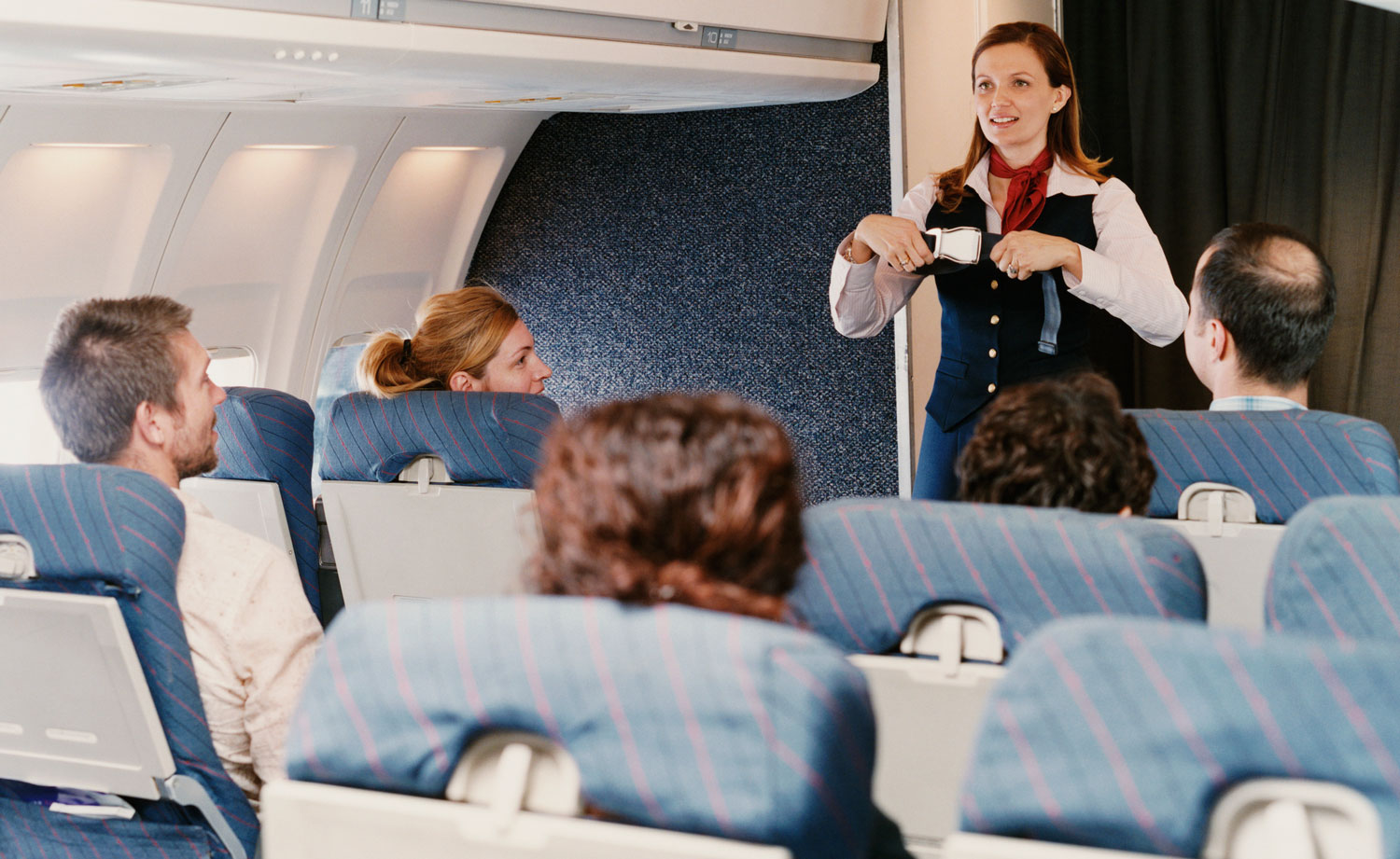 Flight attendant instructor demonstrating an inflight safety procedure to students